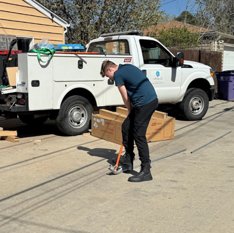 Apollo Energy apprentice loading solar installation equipment into a service truck