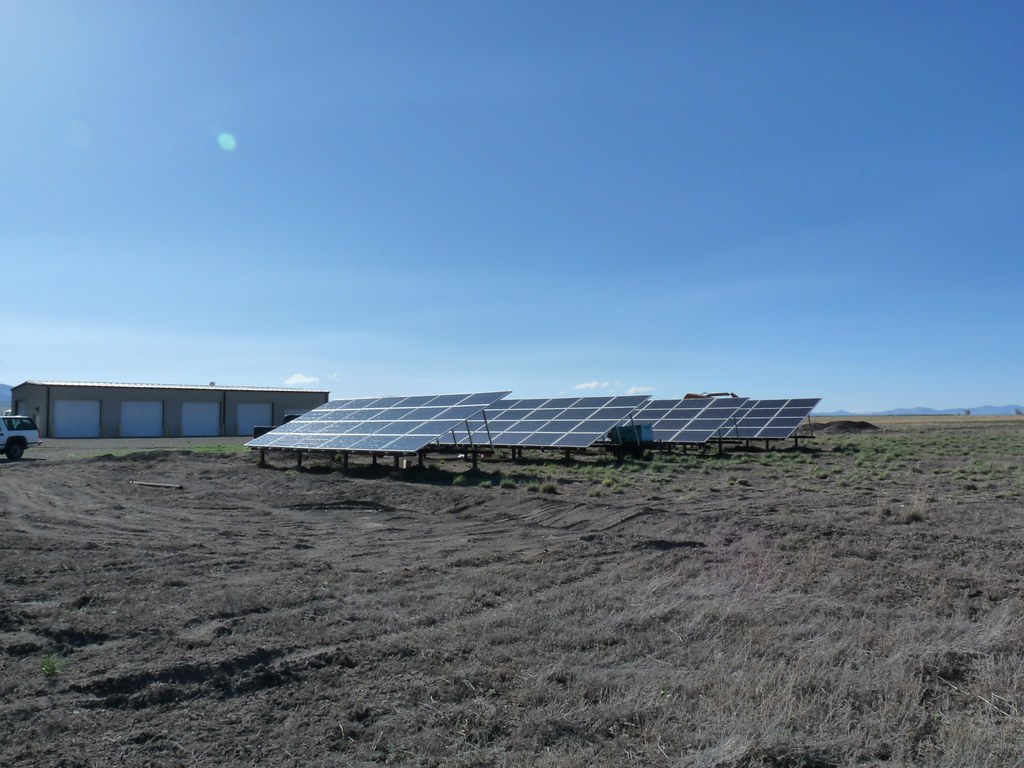 Ground-mounted solar panel array at a Colorado wildlife refuge, similar in scale to a community solar garden