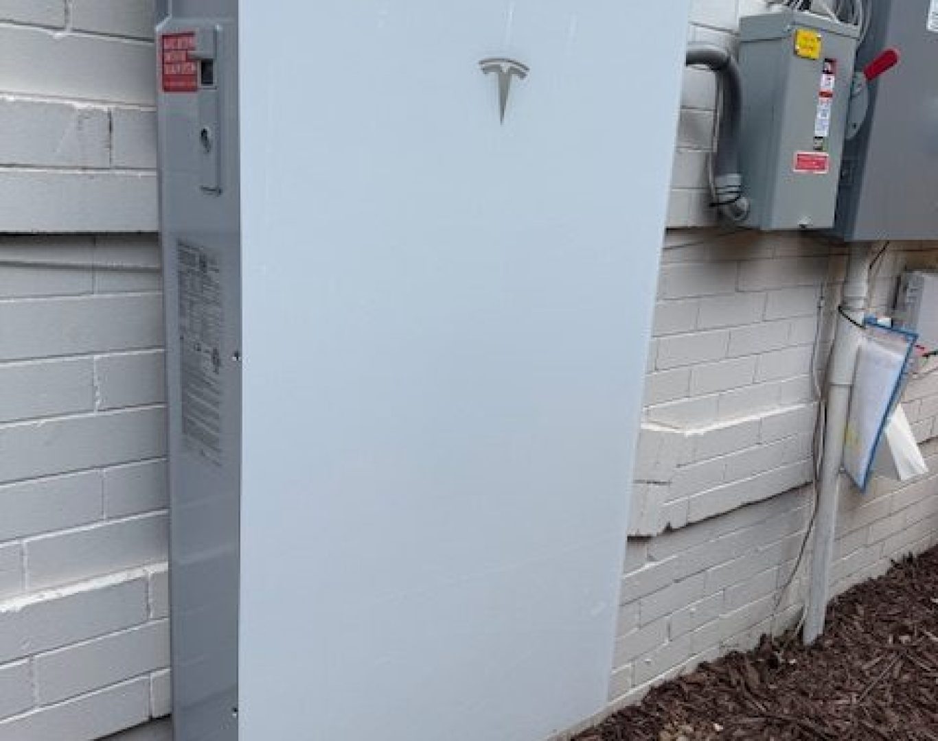Tesla Powerwall battery storage system installed on exterior wall of Denver home